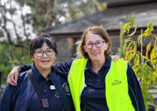 Two women smile at the camera