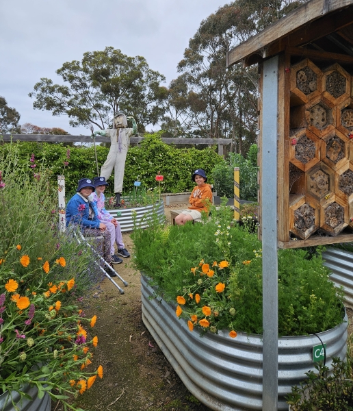 School students sit in a flourishing garden